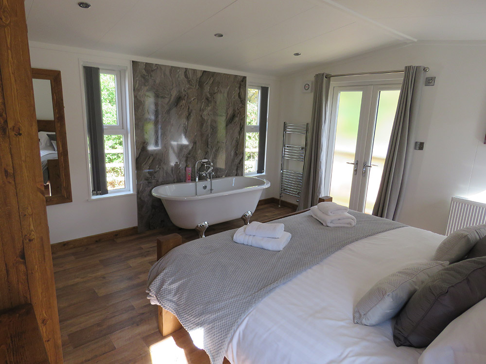 Beech Tree Lodge Bedroom with free standing bath roll top bath